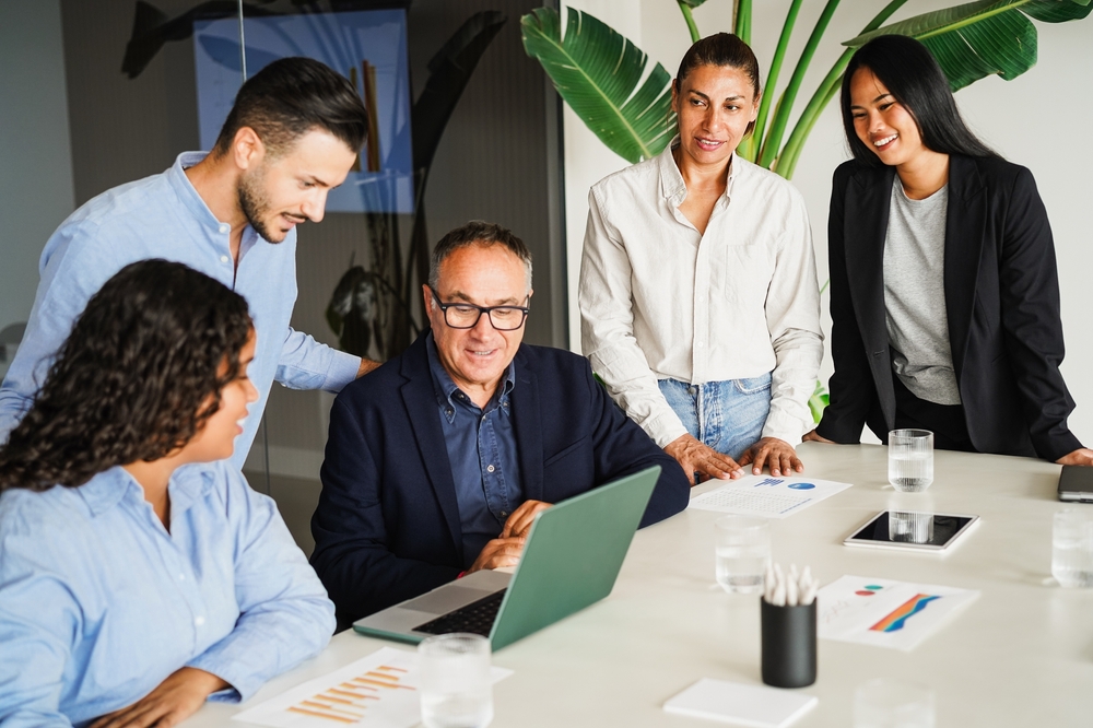 Multigenerational business people sharing ideas inside company office - Multiracial colleagues discussing new financial project